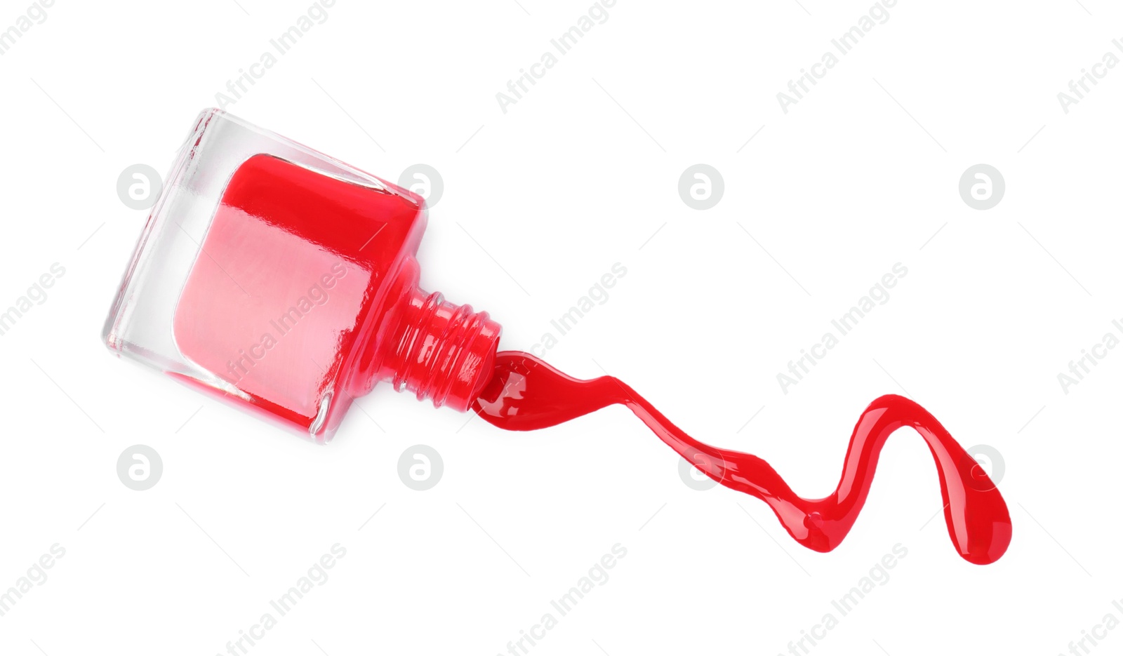 Photo of Overturned bottle of red nail polish isolated on white, top view