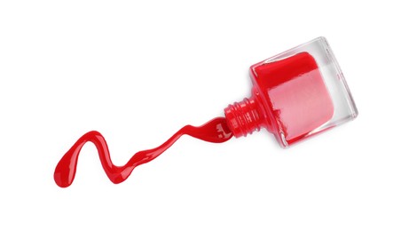 Overturned bottle of red nail polish isolated on white, top view