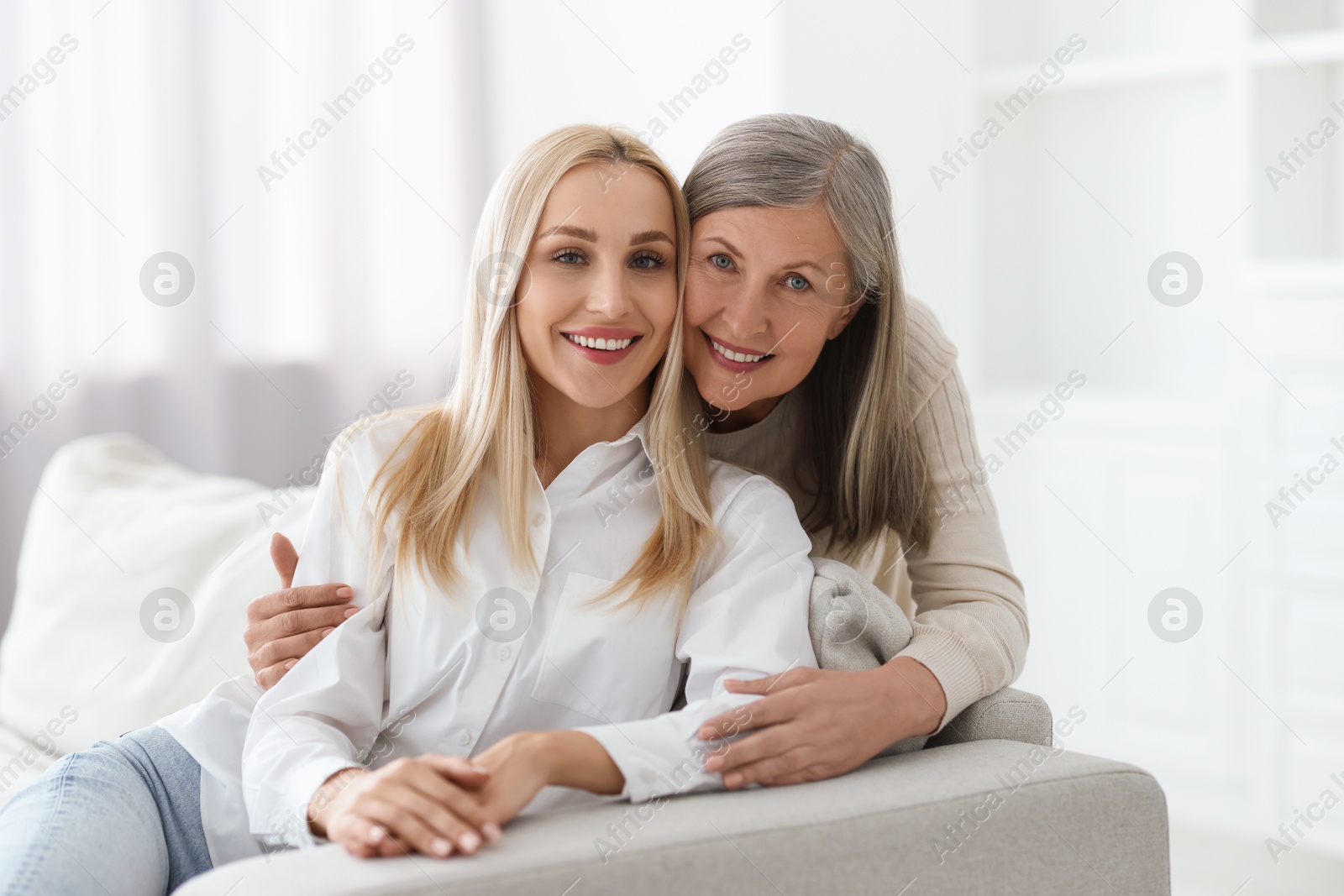 Photo of Family portrait of young woman and her mother at home