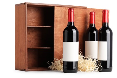 Wooden gift box with wine bottles isolated on white