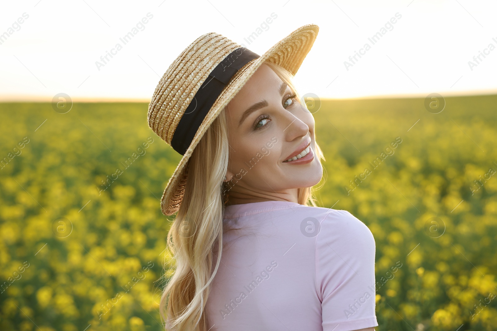 Photo of Portrait of happy young woman in field on spring day