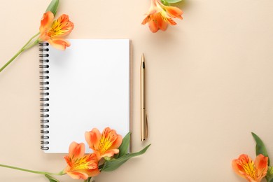 Photo of Guest list. Notebook, pen and beautiful flowers on beige background, flat lay. Space for text