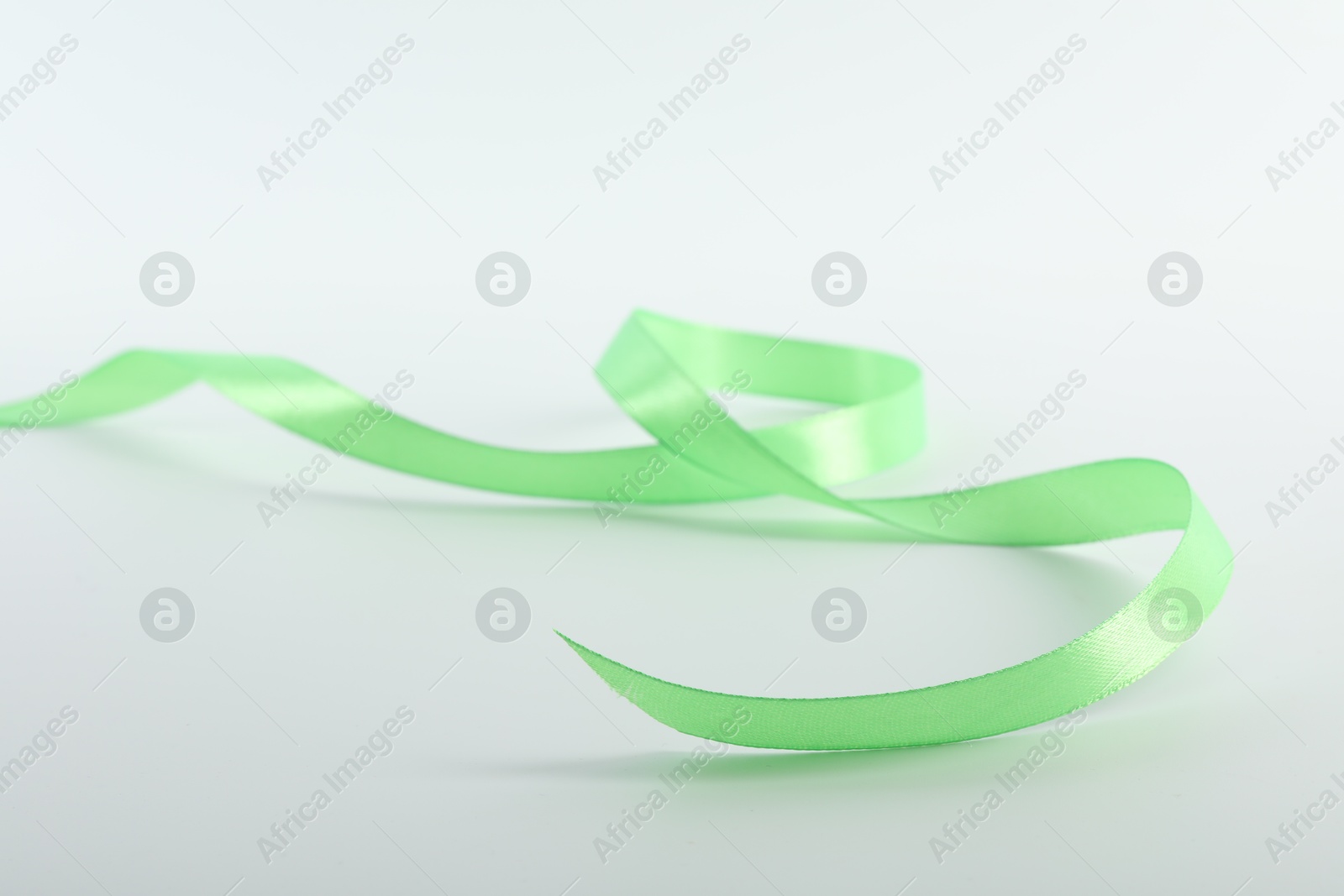 Photo of One beautiful green ribbon isolated on white