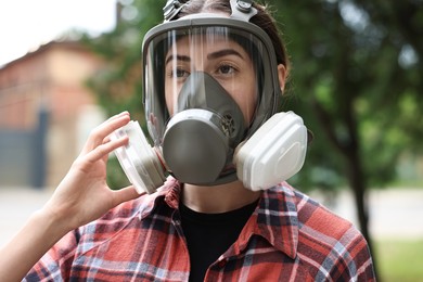 Photo of Woman in respirator mask outdoors. Protective equipment