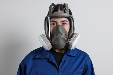 Photo of Worker in respirator mask on grey background
