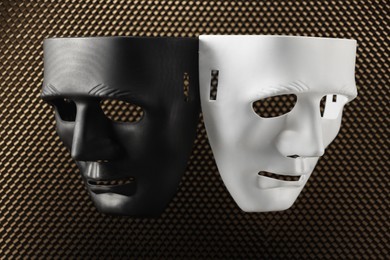 Theater arts. Black and white masks on honeycomb grid, top view