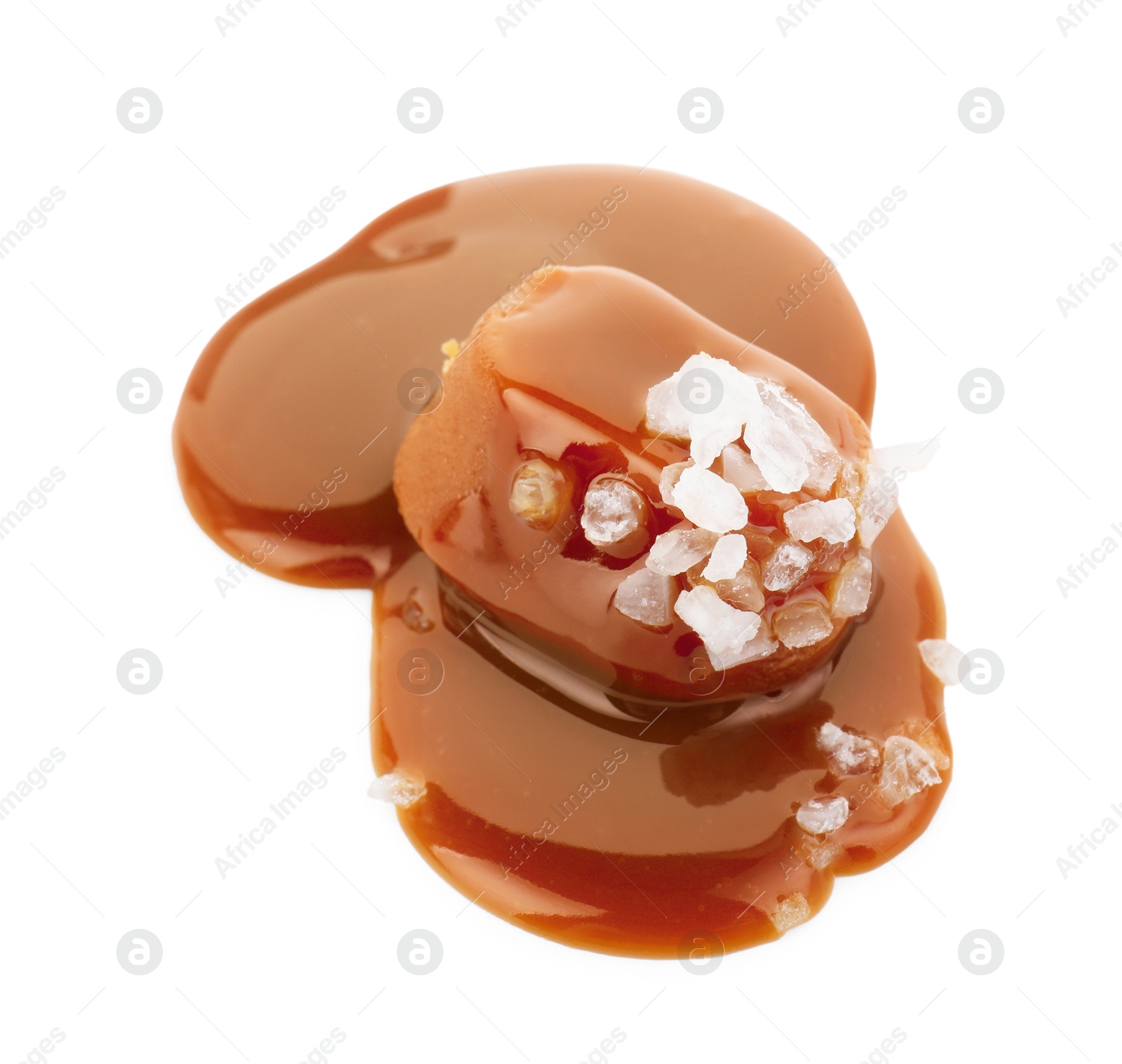 Photo of Yummy candy with caramel sauce and sea salt isolated on white