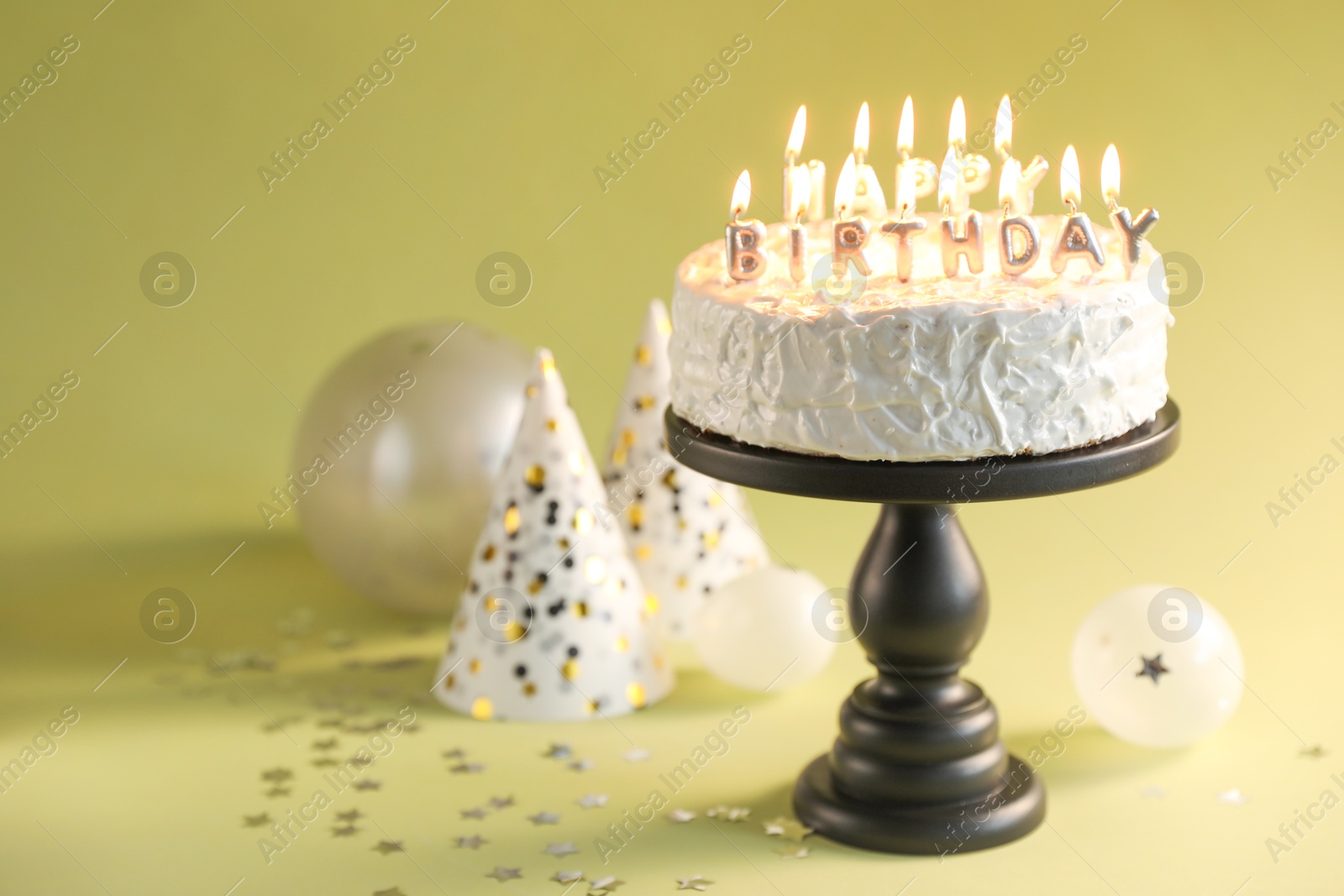 Photo of Tasty birthday cake with burning candles on green background, closeup. Space for text