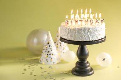 Photo of Tasty birthday cake with burning candles on green background, closeup. Space for text