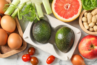 Photo of Many different healthy food on light marble table, flat lay