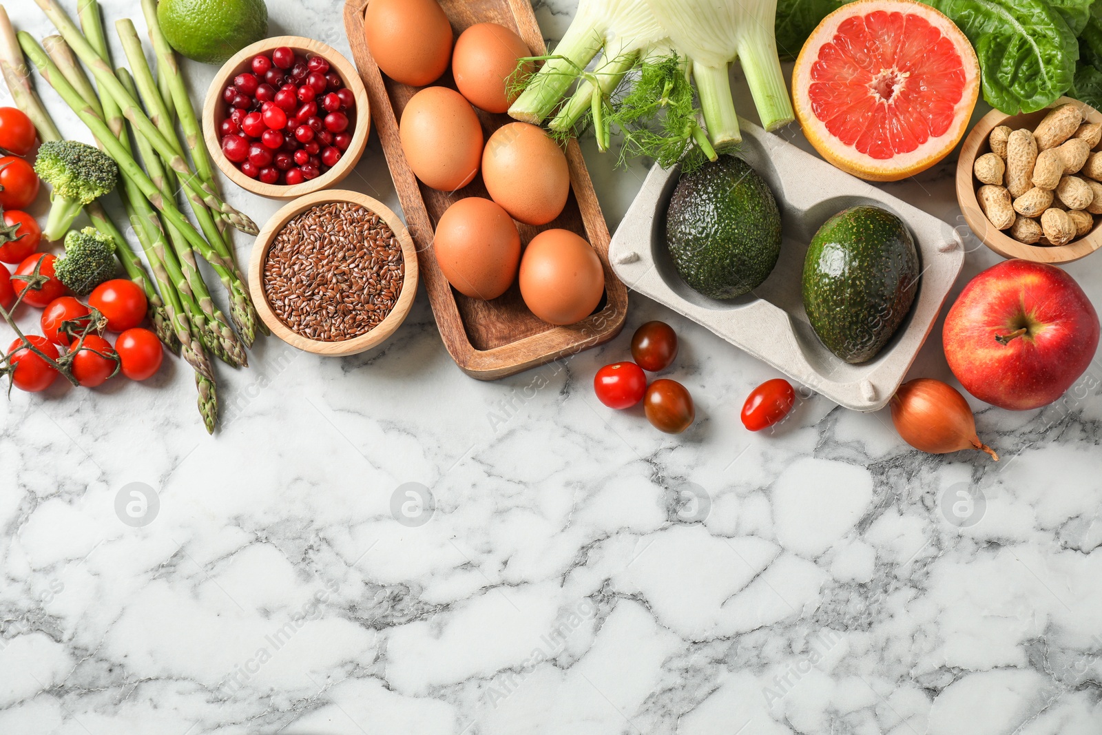 Photo of Many different healthy food on light marble table, flat lay. Space for text