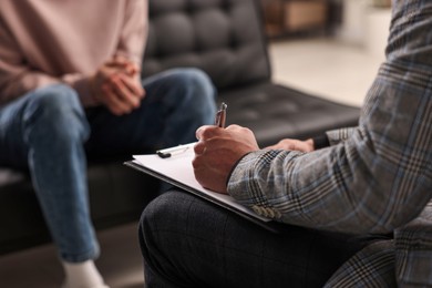 Professional psychotherapist working with patient in office, closeup