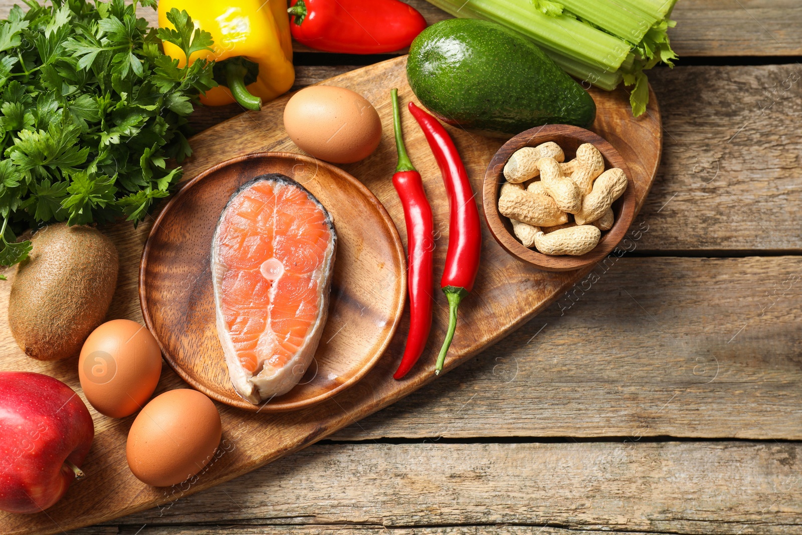 Photo of Healthy meal. Different vegetables and raw salmon on wooden table, flat lay. Space for text