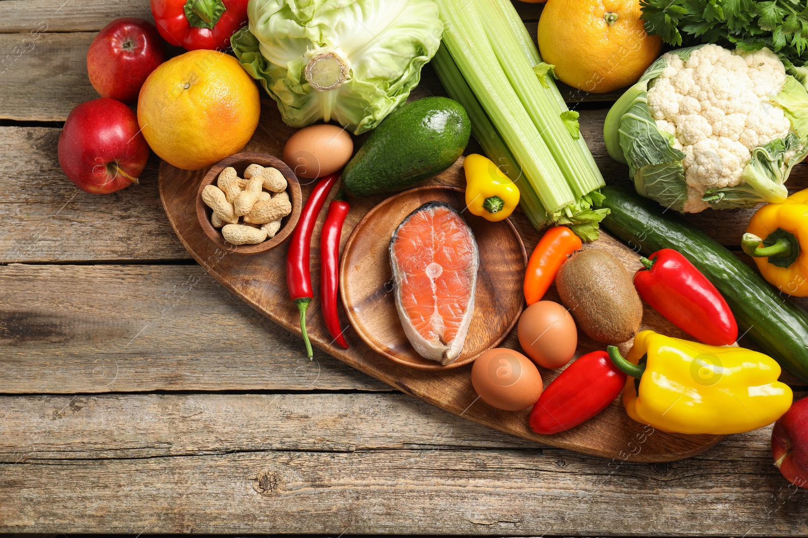 Photo of Healthy meal. Different vegetables and raw salmon on wooden table, flat lay. Space for text