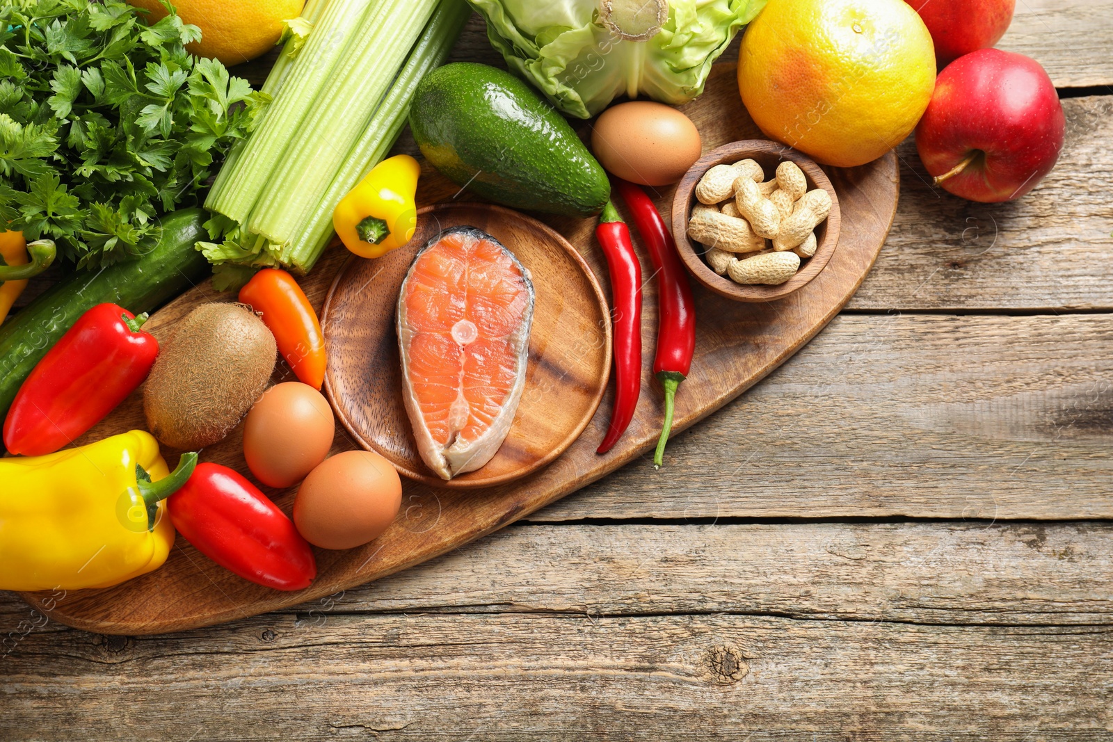 Photo of Healthy meal. Different vegetables and raw salmon on wooden table, flat lay. Space for text