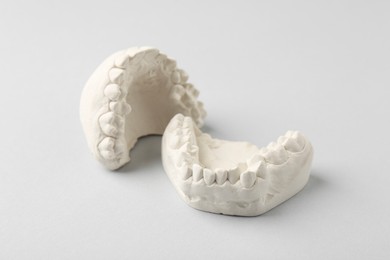 Photo of Dental model with gums on light grey background. Cast of teeth