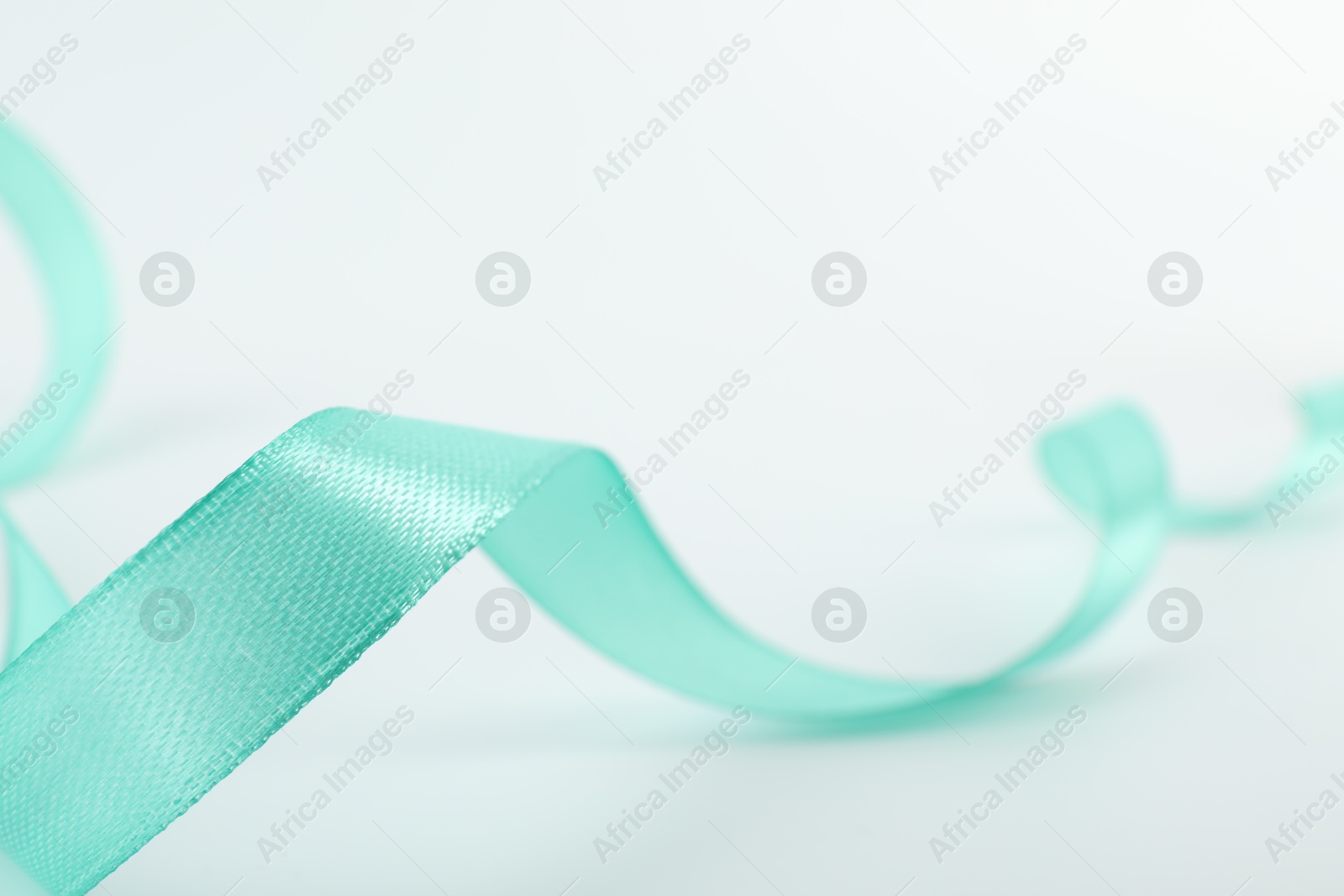 Photo of One beautiful turquoise ribbon isolated on white