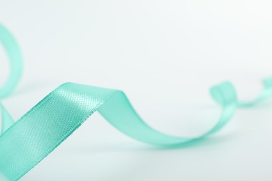 Photo of One beautiful turquoise ribbon isolated on white