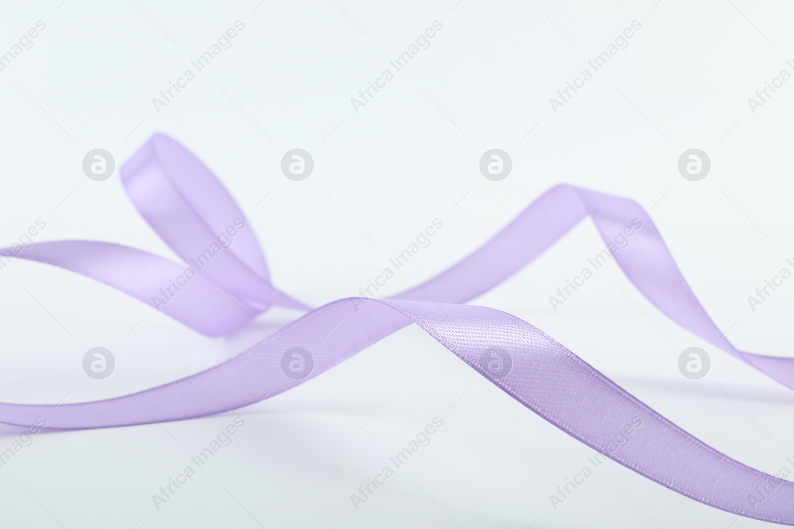 Photo of One beautiful violet ribbon isolated on white