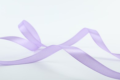 Photo of One beautiful violet ribbon isolated on white