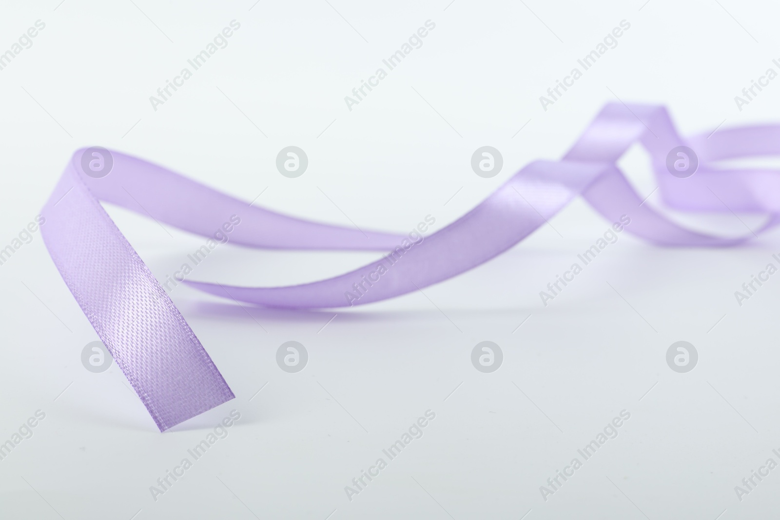 Photo of One beautiful violet ribbon isolated on white