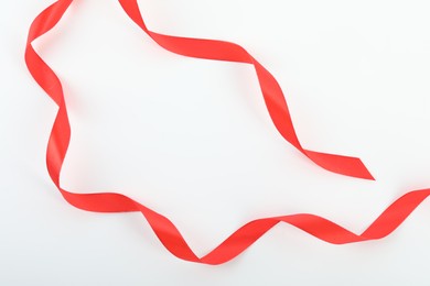 Beautiful red ribbon isolated on white, top view