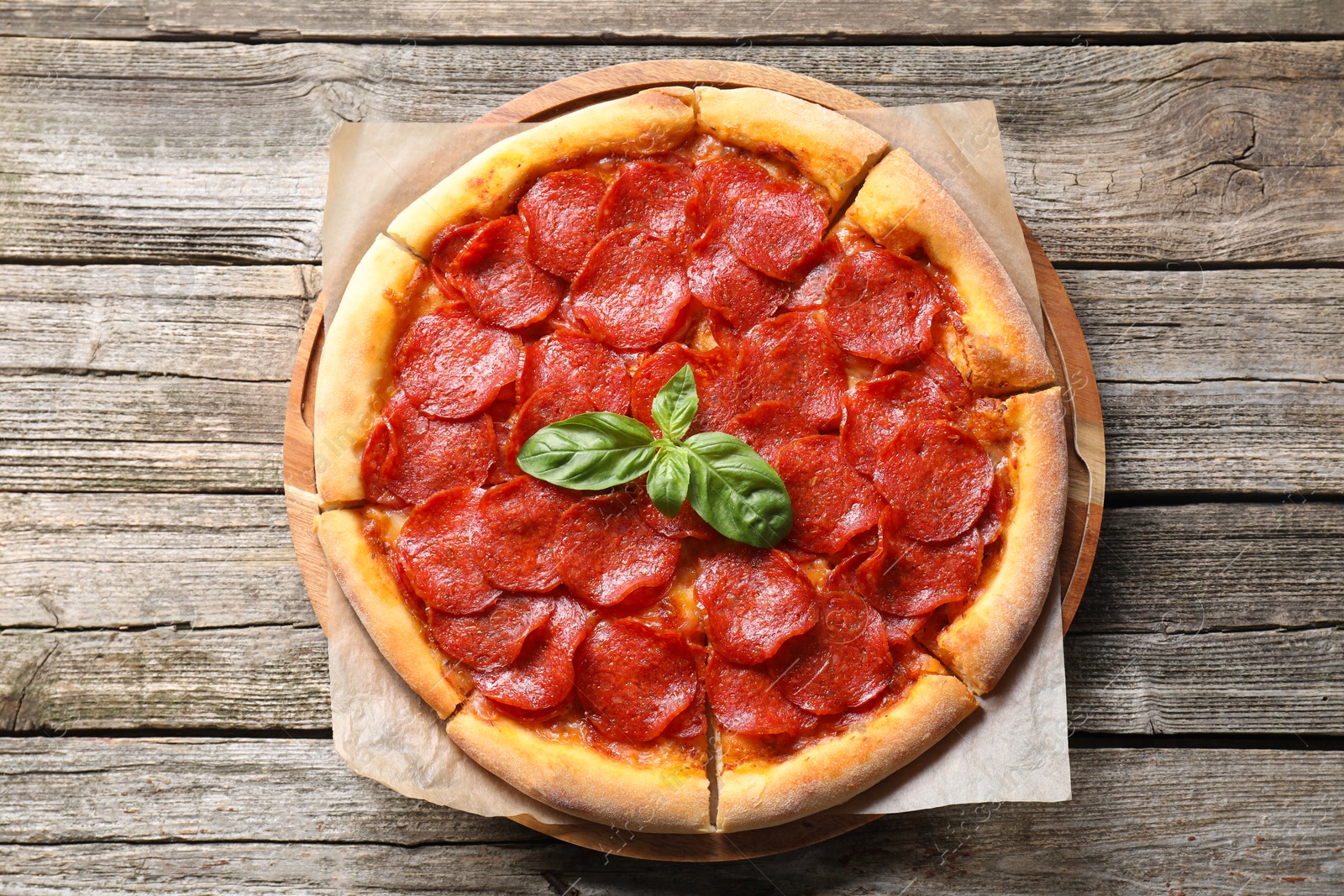 Photo of Tasty pepperoni pizza on wooden table, top view