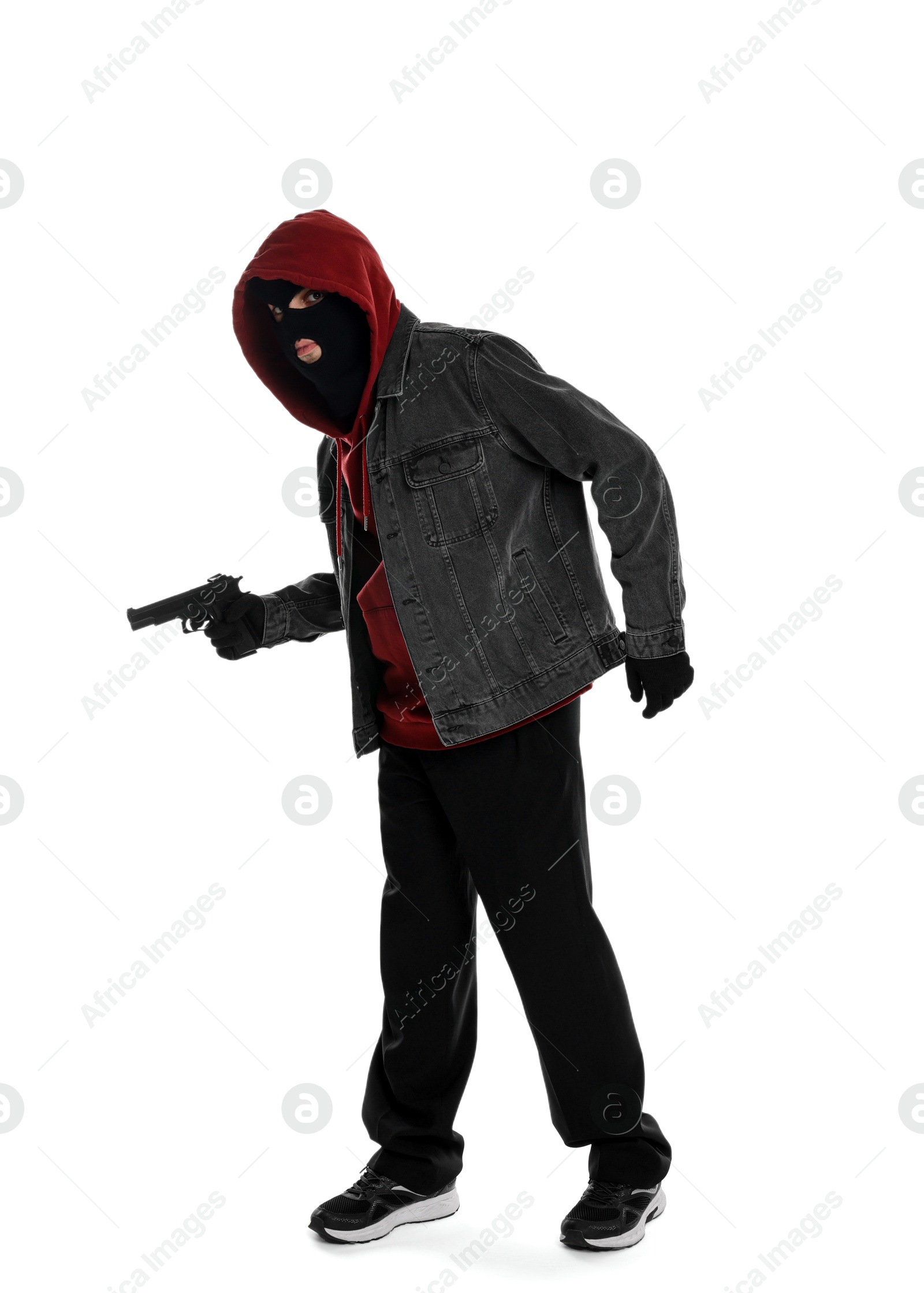 Photo of Thief in balaclava with gun on white background