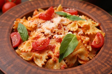 Tasty pasta with tomato, cheese and basil on table, closeup