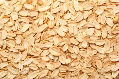 Photo of Fresh peeled peanuts as background, top view