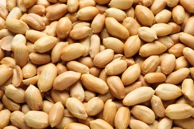 Fresh peeled peanuts as background, above view