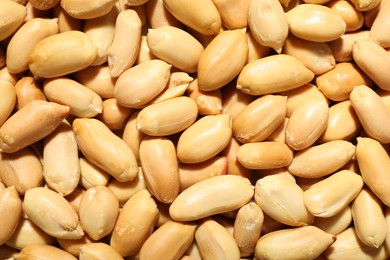 Photo of Fresh peeled peanuts as background, top view