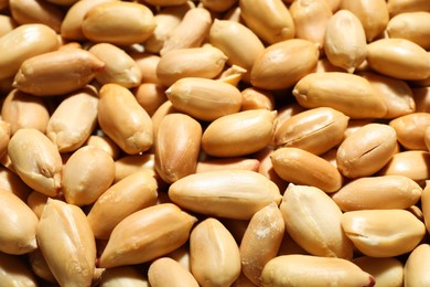 Fresh peeled peanuts as background, closeup view