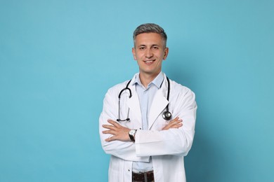 Photo of Doctor with stethoscope on light blue background