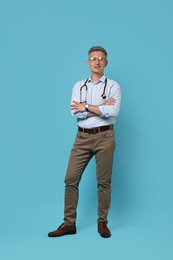 Photo of Doctor with stethoscope on light blue background