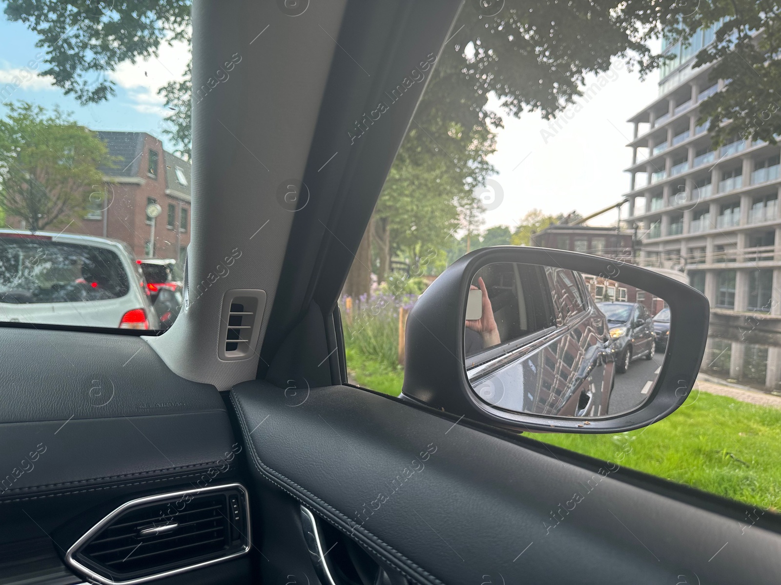 Photo of Cars in traffic jam on city street, view from driver's seat