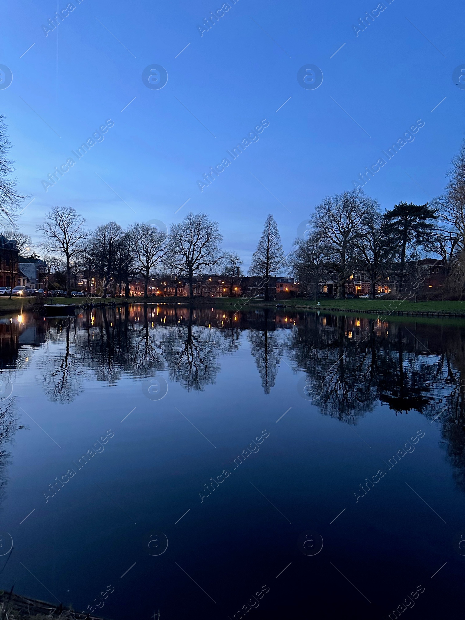 Photo of Scenic view of river and buildings on shore in evening