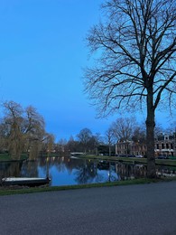 Photo of Beautiful view of lake and buildings under blue sky in evening