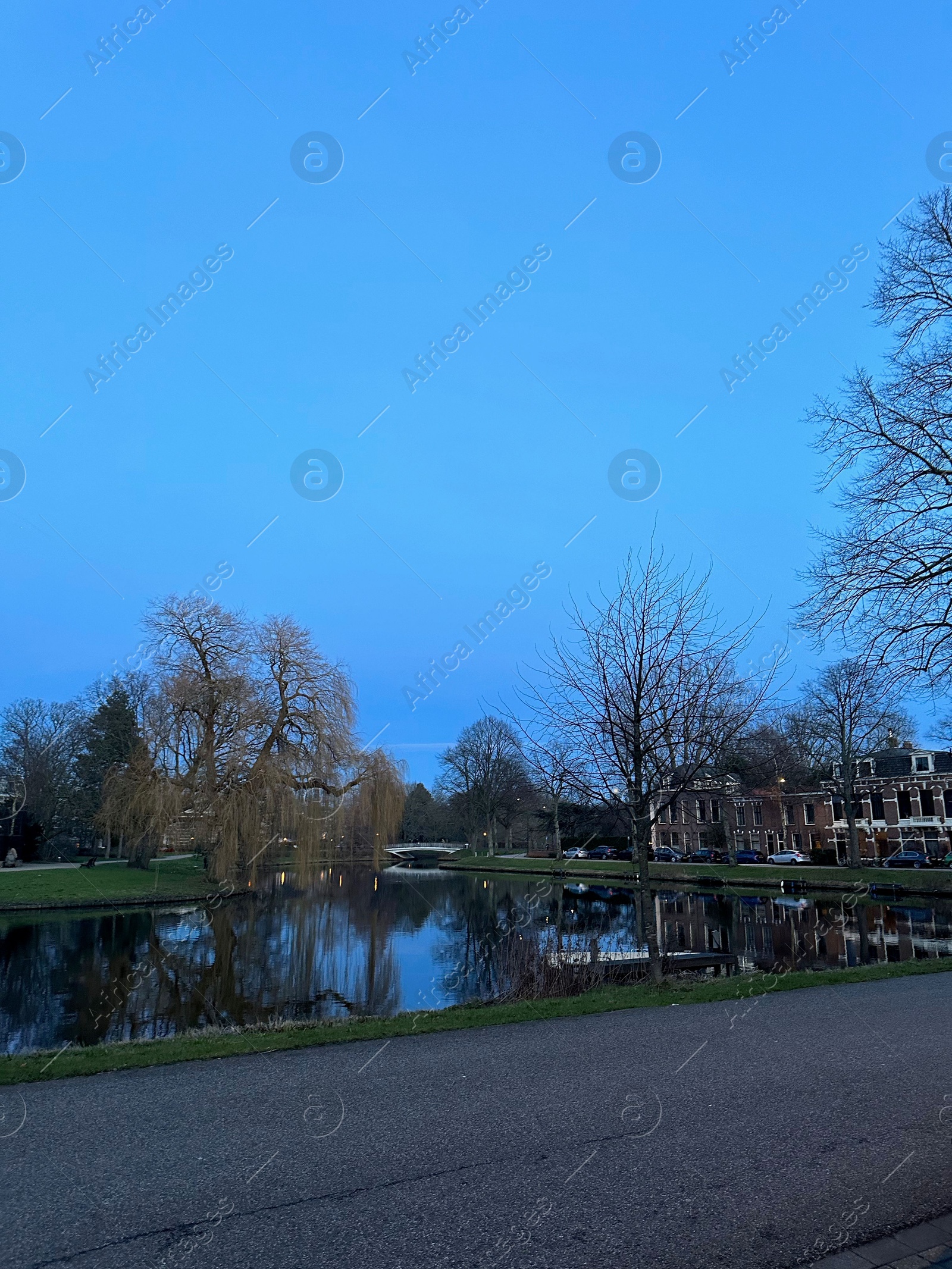 Photo of Beautiful view of lake and buildings under blue sky in evening