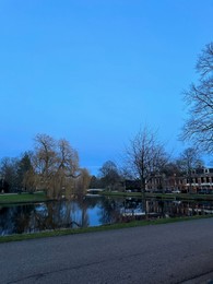 Photo of Beautiful view of lake and buildings under blue sky in evening