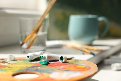 Artist's palette and paints on window sill, closeup