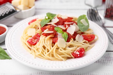 Photo of Tasty pasta with tomato sauce, cheese and basil on white table, closeup