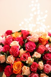 Beautiful bouquet of colorful roses on beige background