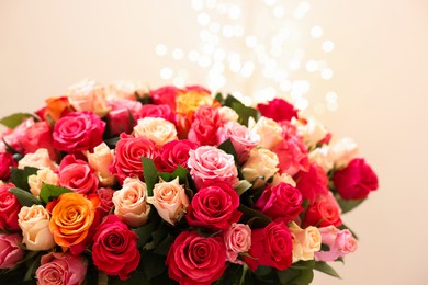 Beautiful bouquet of colorful roses on beige background