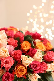 Beautiful bouquet of colorful roses on beige background