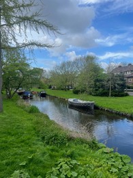 Photo of Canal with moored boats on sunny day