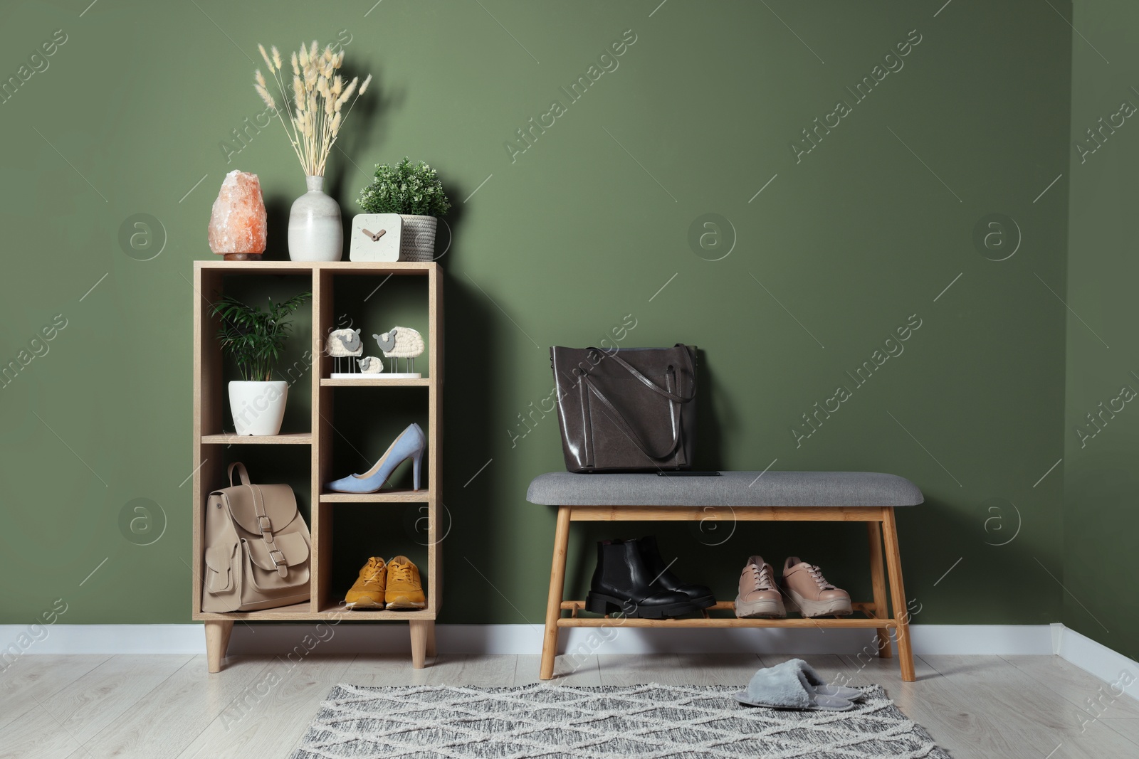 Image of Modern hallway with stylish furniture and decorative elements near sage green wall. Interior design