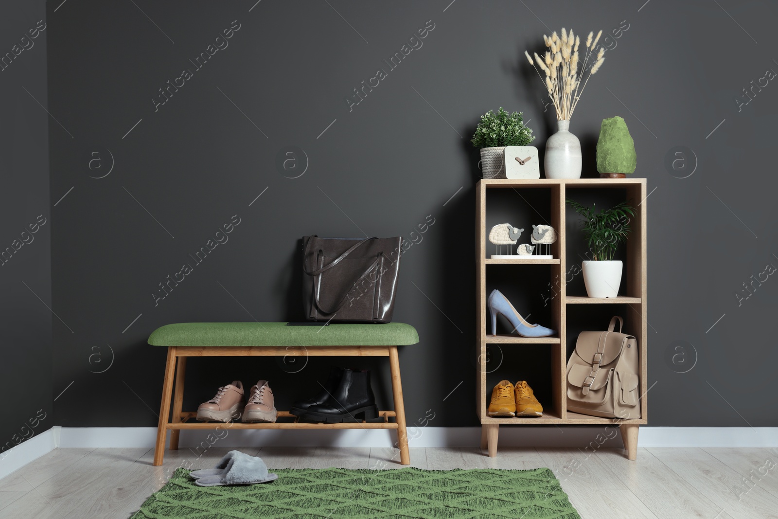 Image of Modern hallway with stylish furniture and decorative elements near grey walls. Interior design