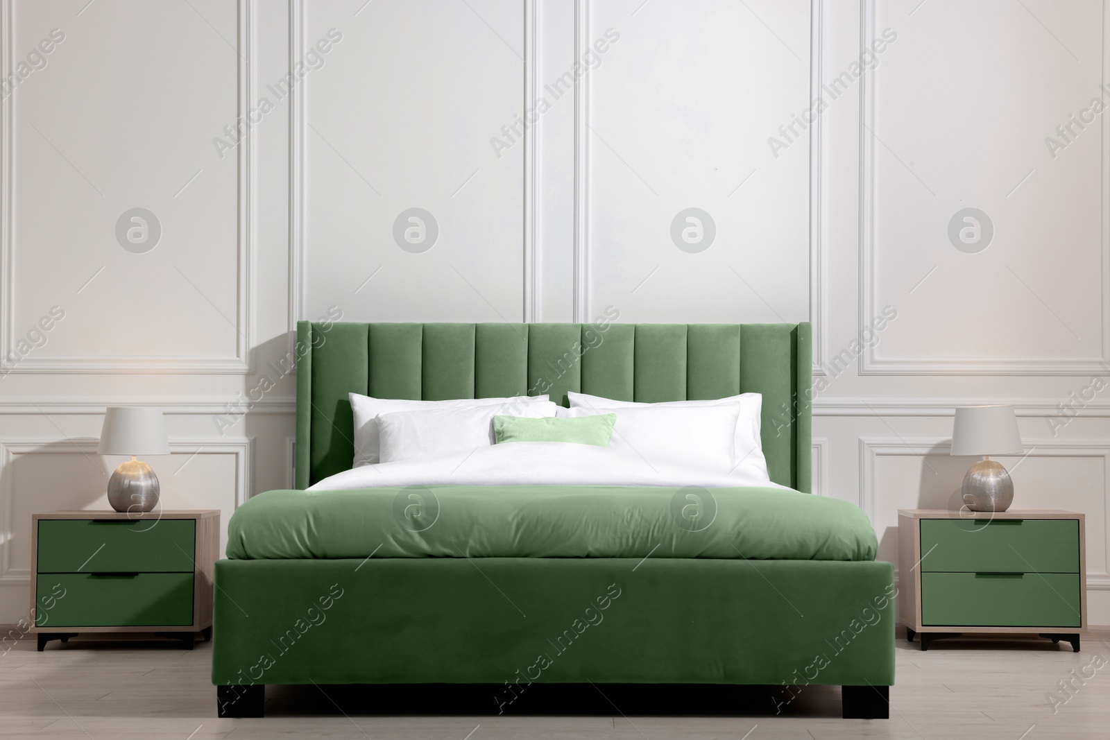 Image of Comfortable sage green bed in room. Interior design