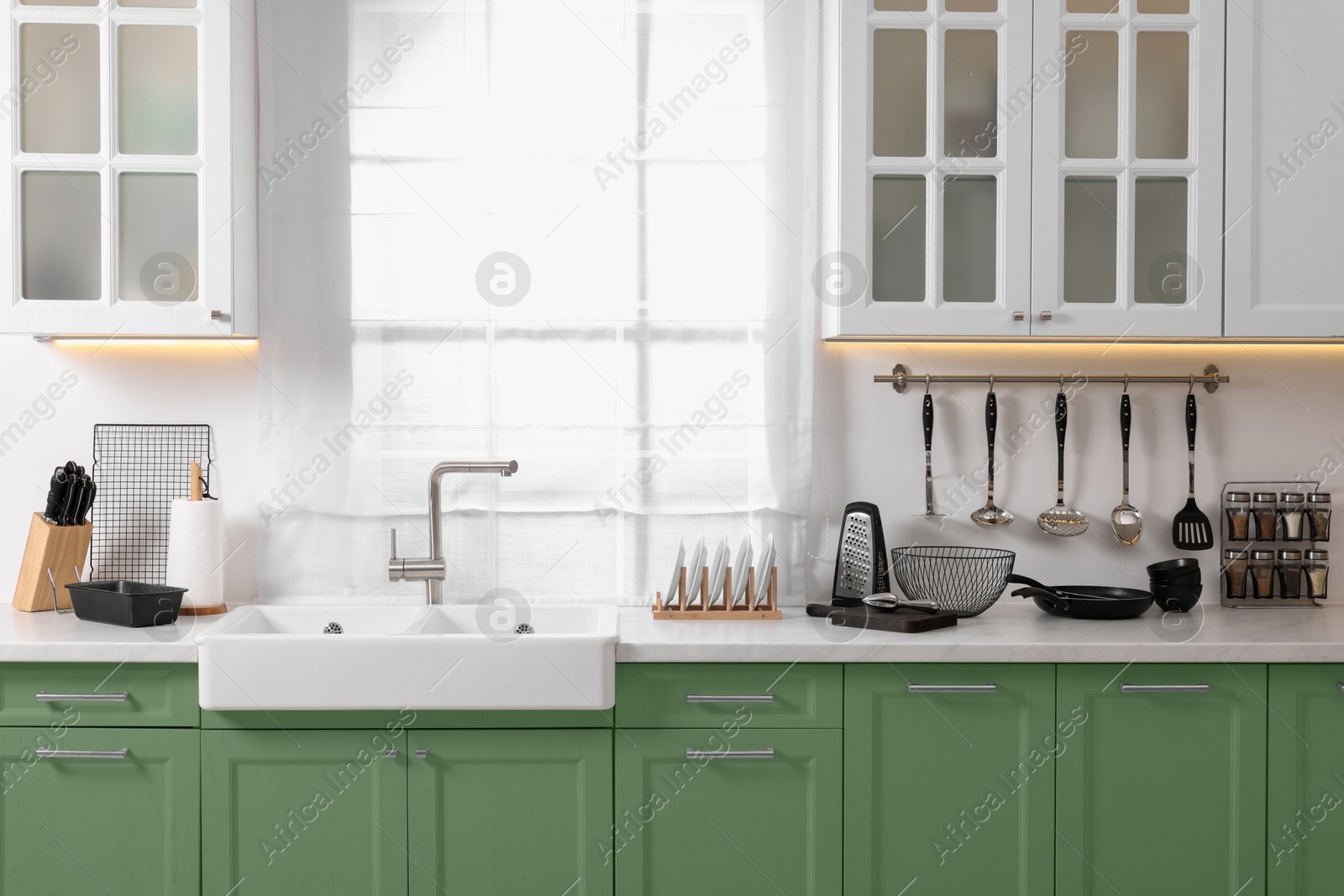 Image of Beautiful kitchen interior with cooking utensils and stylish furniture